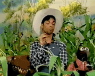 Prince dressed as farmer running away from muppets